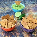 keto tortilla chips in bowls with guacamole and vegetables