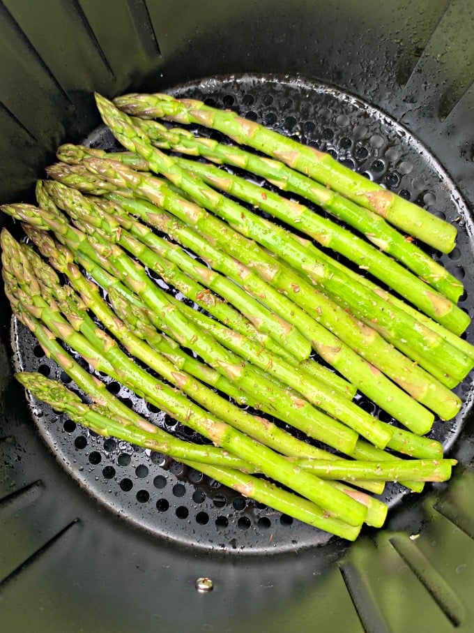 raw asparagus in an air fryer