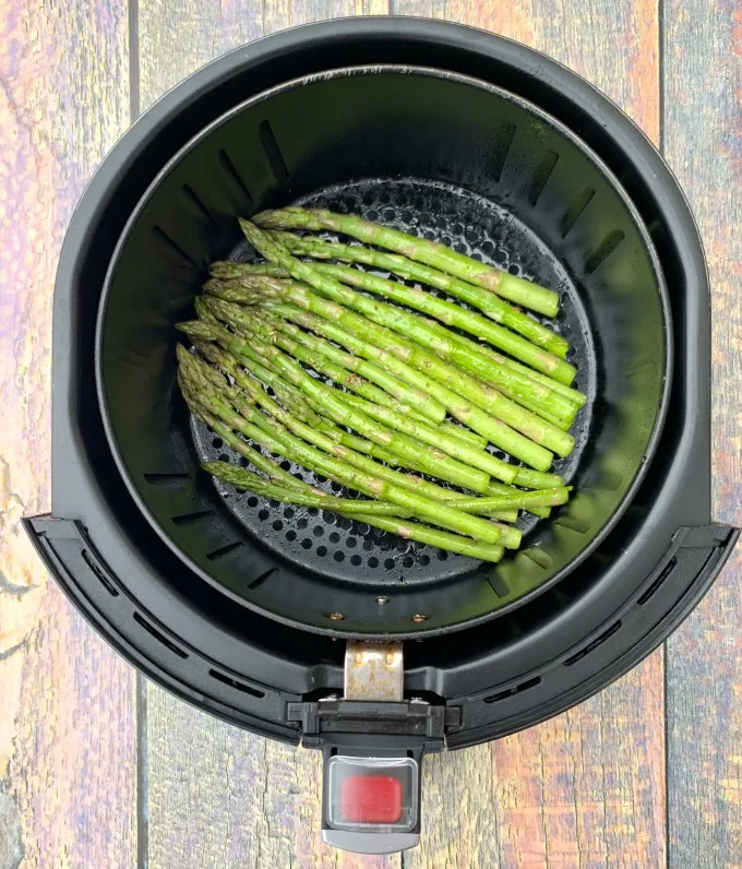 raw asparagus in an air fryer