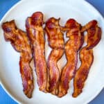cooked air fryer bacon on a white plate