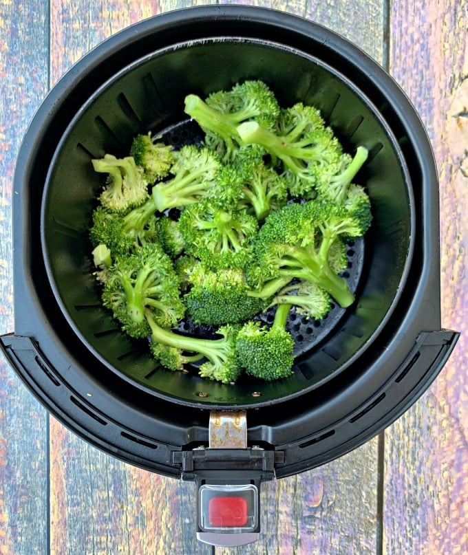 raw and cut broccoli in an air fryer