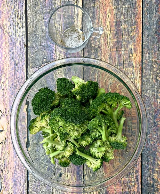 raw and cut broccoli in a glass bowl