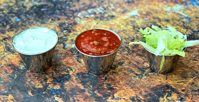 sour cream, salsa, and lettuce in small bowls