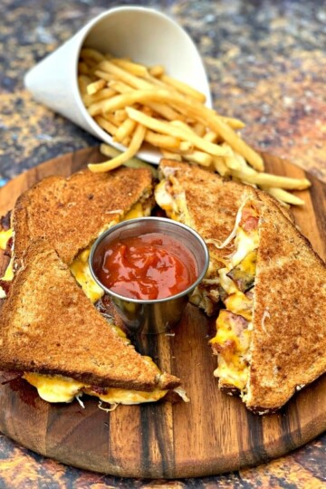 air fryer bacon grilled cheese sandwiches sliced in half with french fries