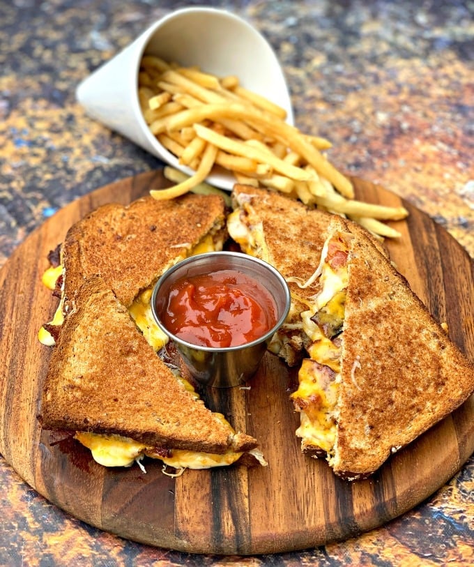 air fryer bacon grilled cheese sandwiches sliced in half with french fries