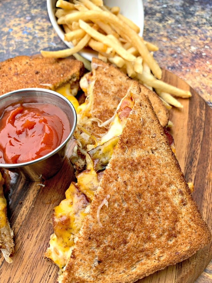 air fryer bacon grilled cheese sandwiches sliced in half with french fries