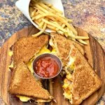 air fryer bacon grilled cheese sandwiches sliced in half with french fries