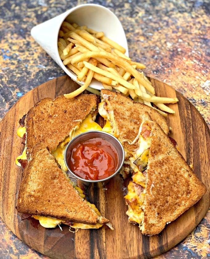 air fryer bacon grilled cheese sandwiches sliced in half with french fries