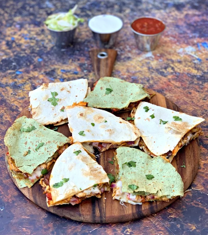 air fryer chicken quesadillas on a brown board