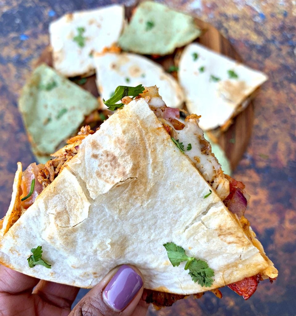 person holding air fryer chicken quesadillas