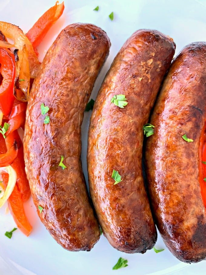 cooked air fryer sausage on a plate with peppers