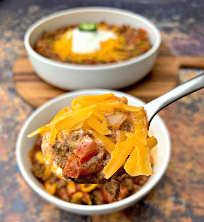 spoonful of keto beef chili with shredded cheese