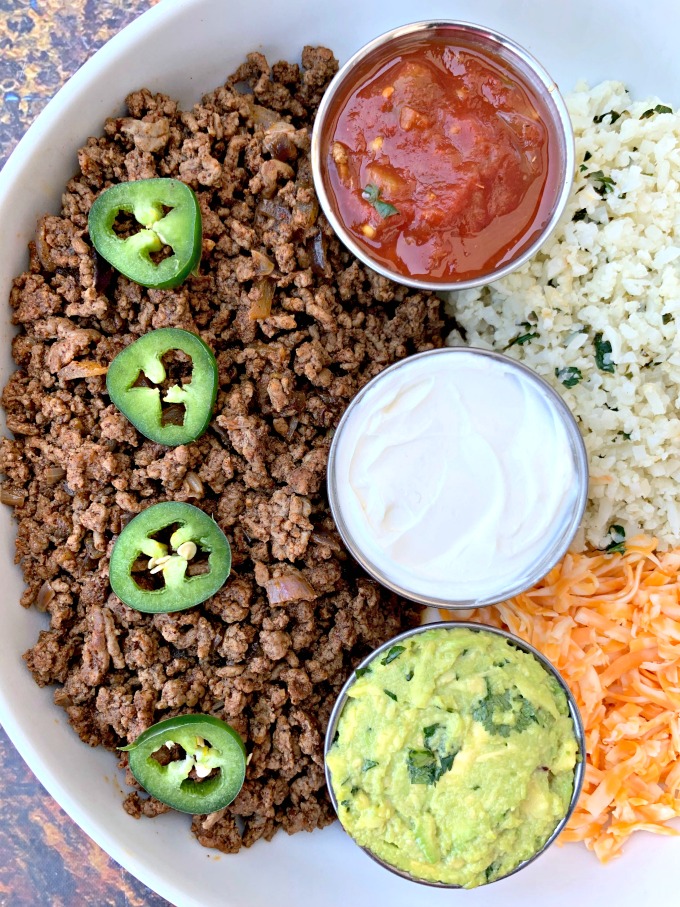 keto low carb tacos in a white bowl with cilantro lime cauliflower rice, salsa, guacamole, and salsa