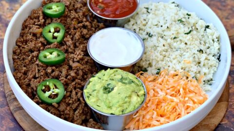 keto low carb tacos in a white bowl with cilantro lime cauliflower rice, salsa, guacamole, and salsa