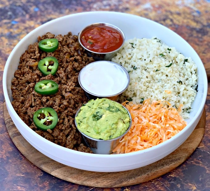 keto low carb tacos in a white bowl with cilantro lime cauliflower rice, salsa, guacamole, and salsa