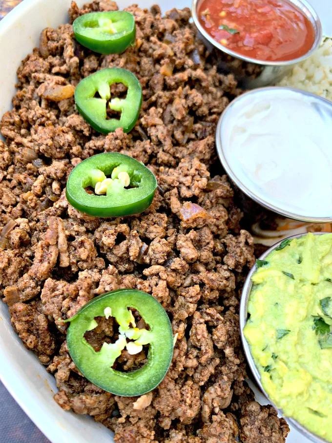 keto taco bowl with ground beef and jalapenos in a white bowl