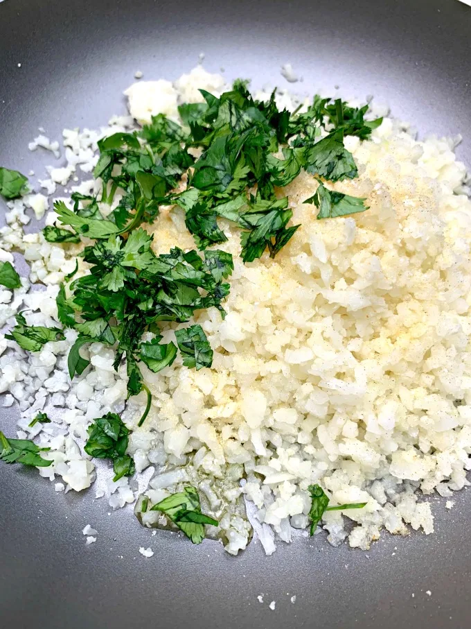 riced cauliflower and cilantro in a skillet