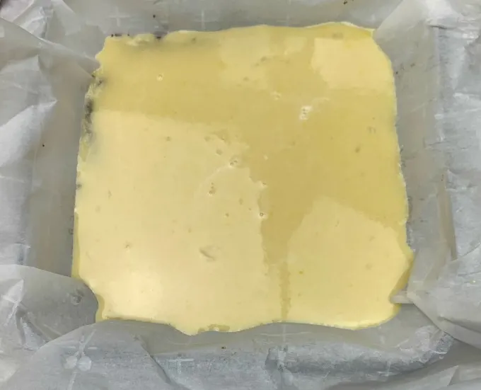 keto lemon bars filling in a pan prior to baking