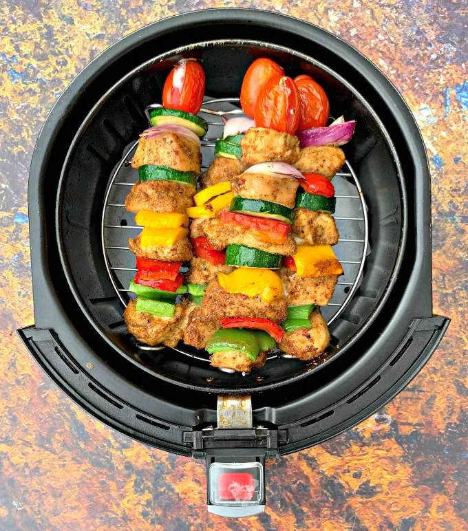 air fryer grilled chicken kebobs on a white plate in an air fryer