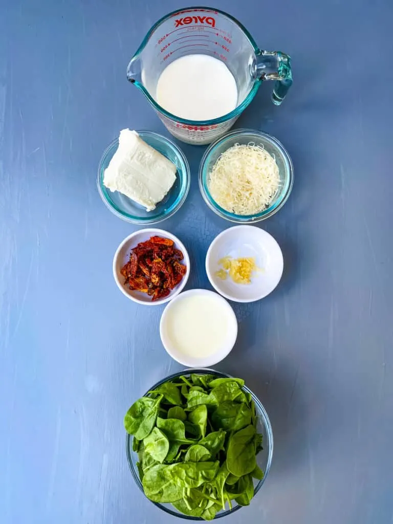 almond milk, cream cheese, Parmesan cheese, garlic, sundried tomates, and fresh spinach in separate bowls