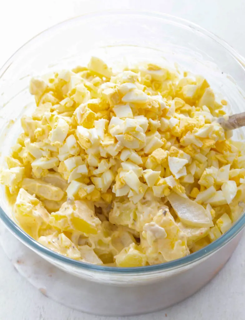 Instant Pot cooked potatoes in a glass bowl with sliced eggs