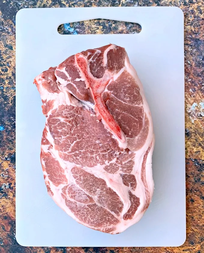 raw pork shoulder butt on a cutting board
