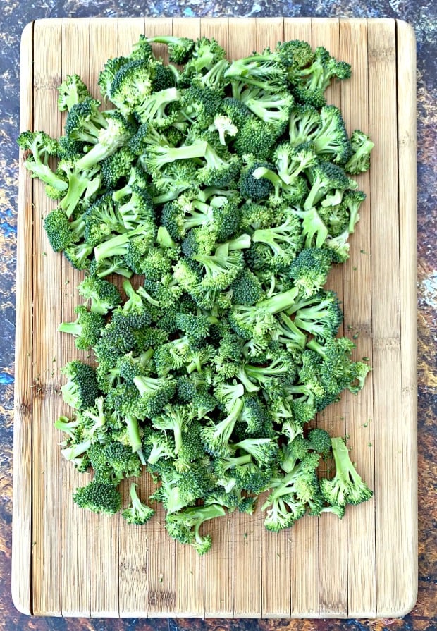 raw chopped broccoli on a cutting board