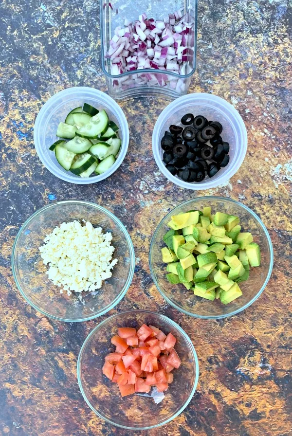 ingredients for keto zucchini noodle pasta salad in different bowls