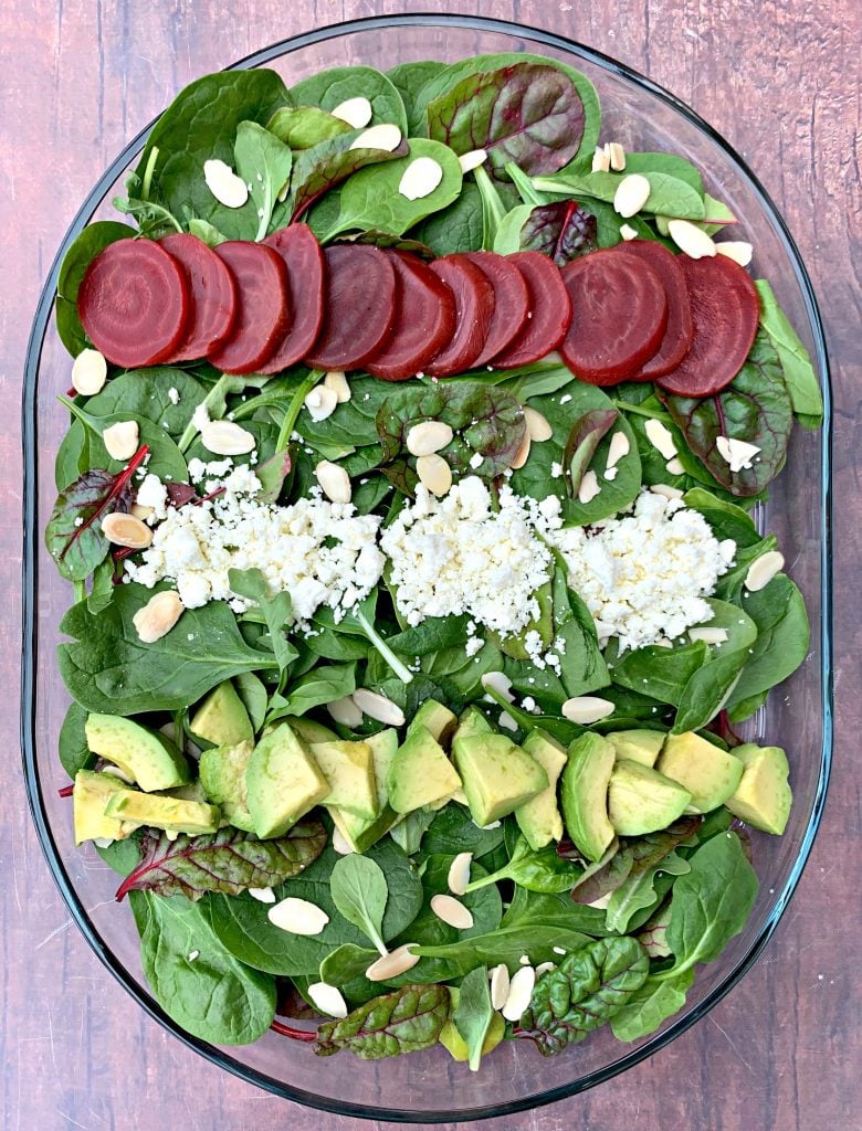 green goddess beet salad on a serving plate with dressing