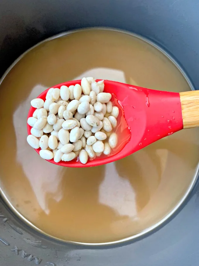 navy beans in an Instant Pot with chicken broth