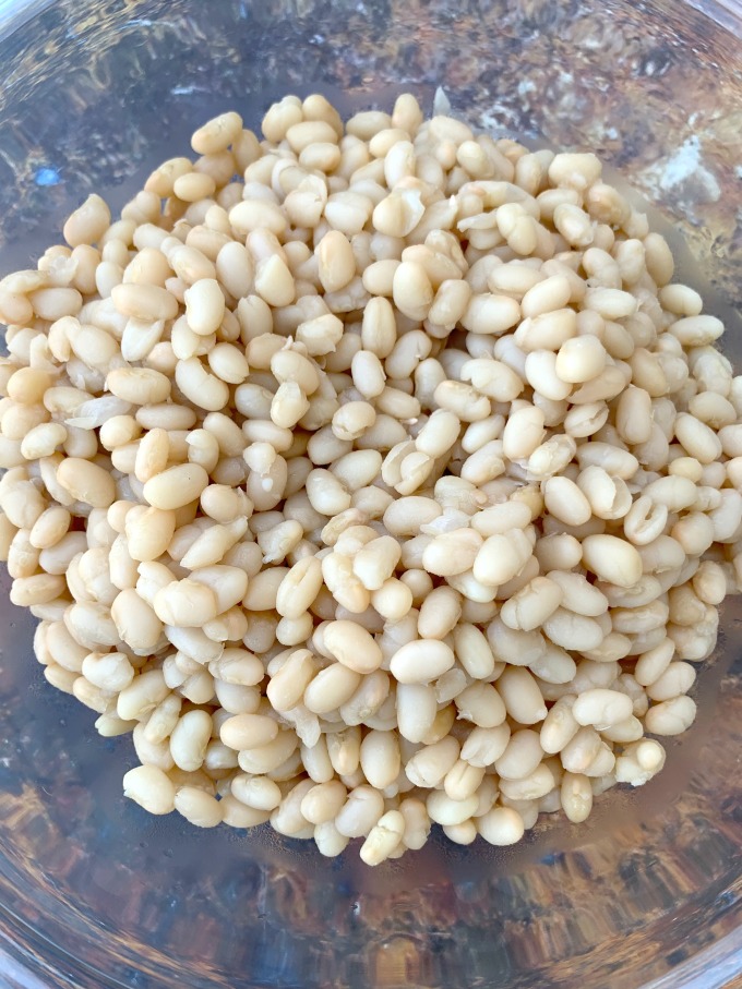 cooked navy beans in a glass bowl