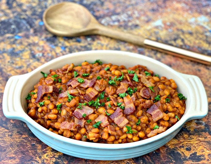 instant pot baked beans with bacon in a blue bowl