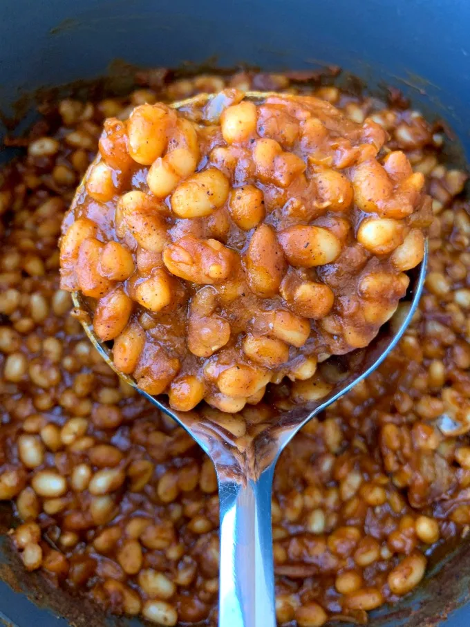 spoon of instant pot baked beans with bacon in an Instant Pot