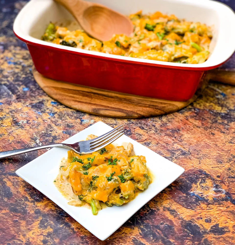 Keto Broccoli Cheese Casserole on a white plate and in a red baking dish