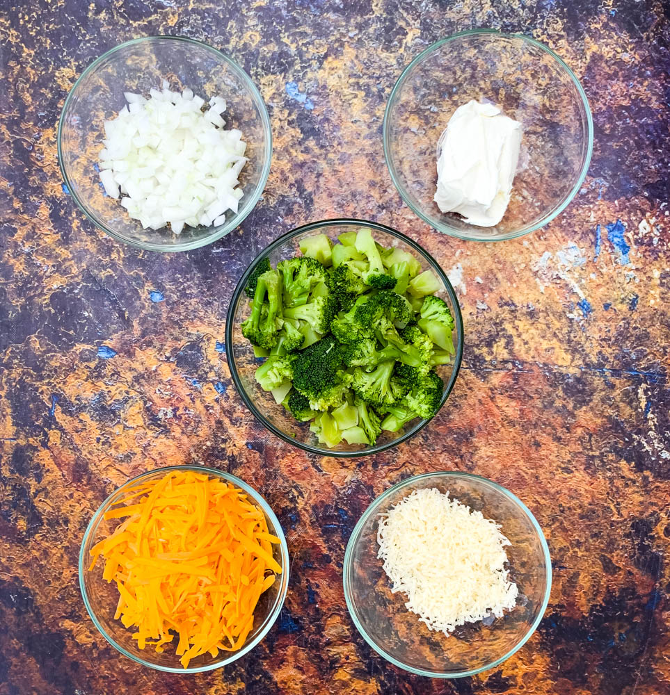 sliced cheese, cream cheese, and steamed broccoli in glass bowls