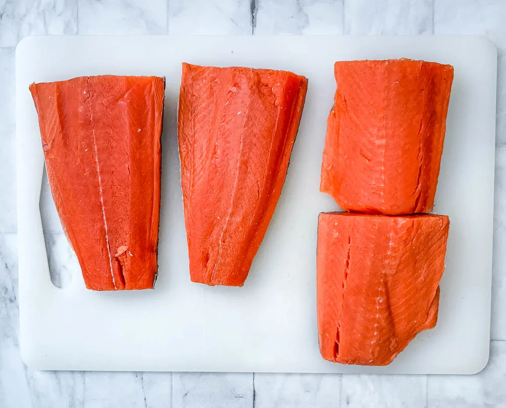 raw Alaskan salmon on a cutting board