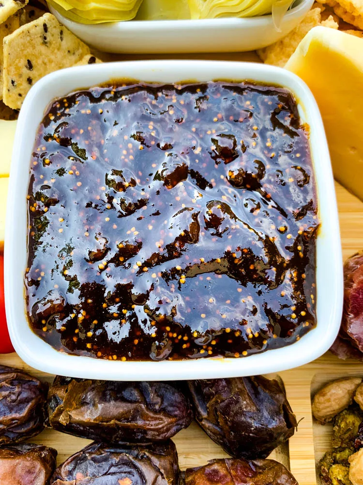 close up photo of fig spread in a bowl on a charcuterie board