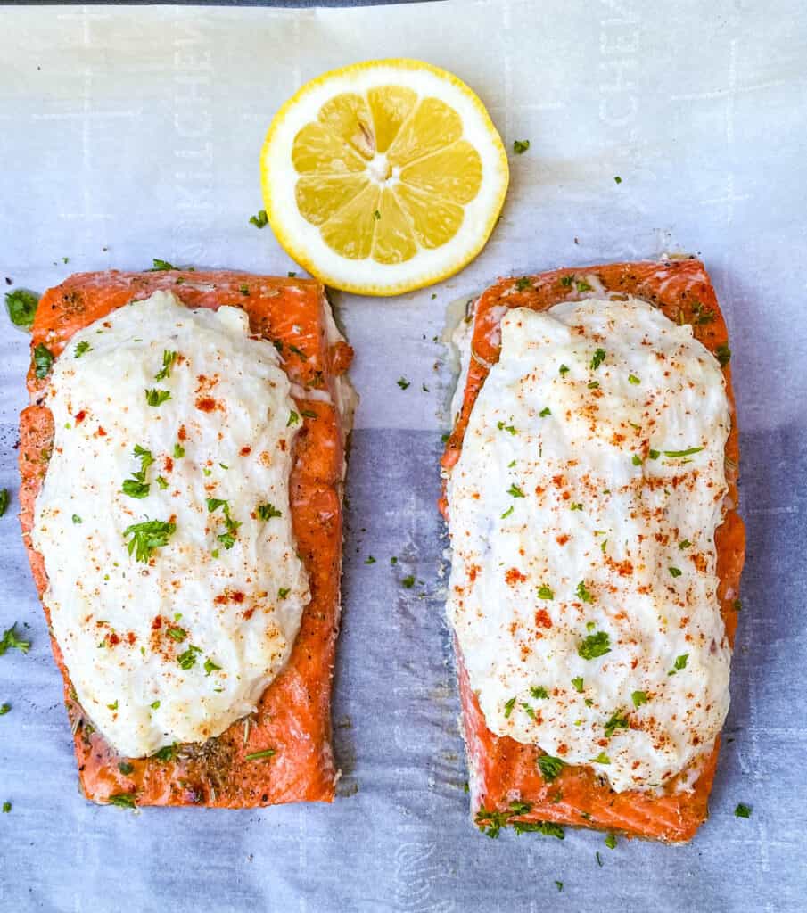 crab stuffed salmon with fresh lemon on parchment paper