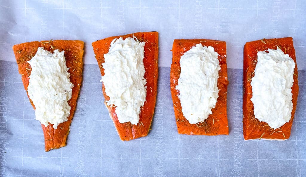 raw crab stuffed salmon on parchment paper