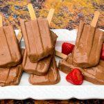 keto low fudge popsicle bars on a white plate with strawberries