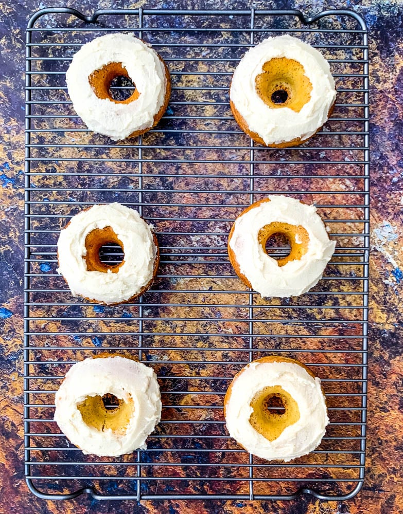 keto low carb donuts with frosted glaze on a cooling rack