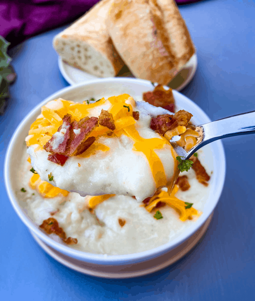 a spoonful of Instant Pot Baked Potato Soup in a white bowl