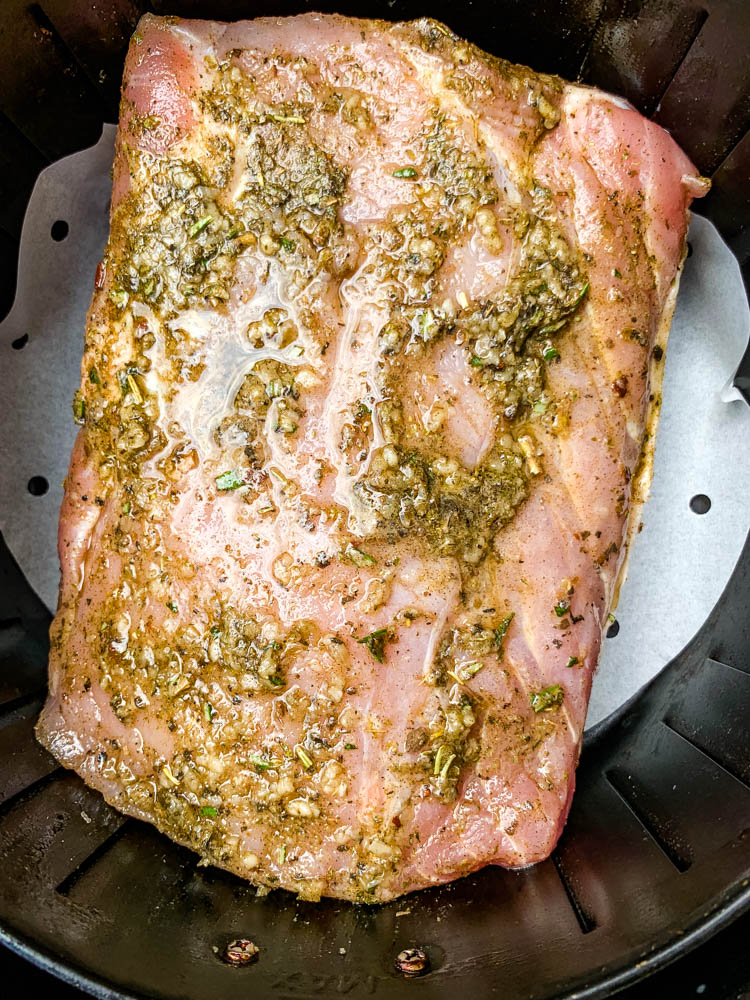 raw air fryer pork loin in an air fryer basket