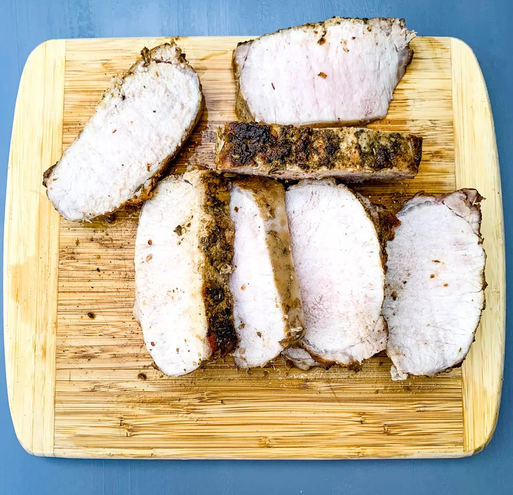 air fryer pork loin sliced on a cutting board