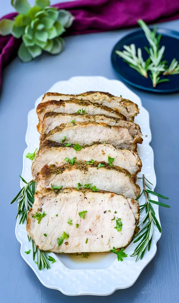 air fryer pork loin sliced on a white platter