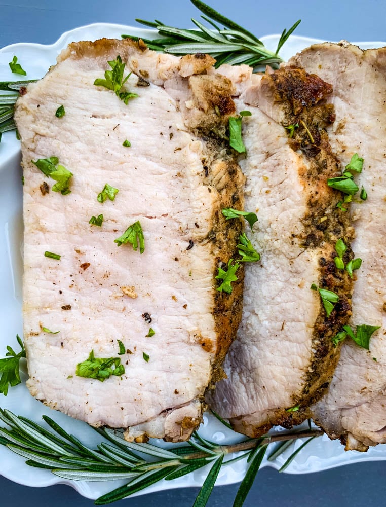 air fryer pork loin sliced on a white platter