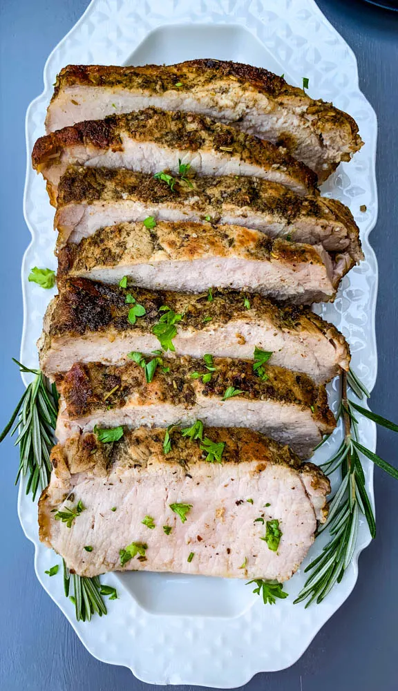 air fryer pork loin sliced on a white platter