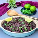 instant pot black beans in a blue bowl with cilantro and lime