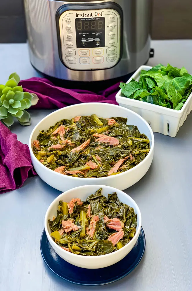 instant pot collard greens in white bowls with smoked turkey with an Instant Pot in back