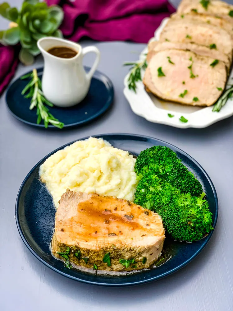 Instant Pot Pork Loin on a blue plate with cauliflower mash and broccoli